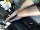 A woman in black stockings is sitting in a car.