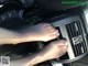 A woman's feet in the center console of a car.