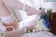 A woman in a wedding dress holding a bouquet of flowers.