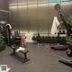 A gym with weights and weightlifting equipment in it.