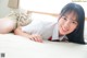 A woman laying on a bed smiling at the camera.