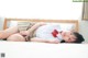 A woman in a school uniform laying on a bed.