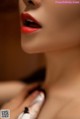 A close up of a woman's face with red lipstick.