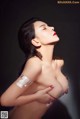 A woman with a bandage wrapped around her breasts.