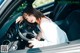 A woman sitting in the driver's seat of a car.